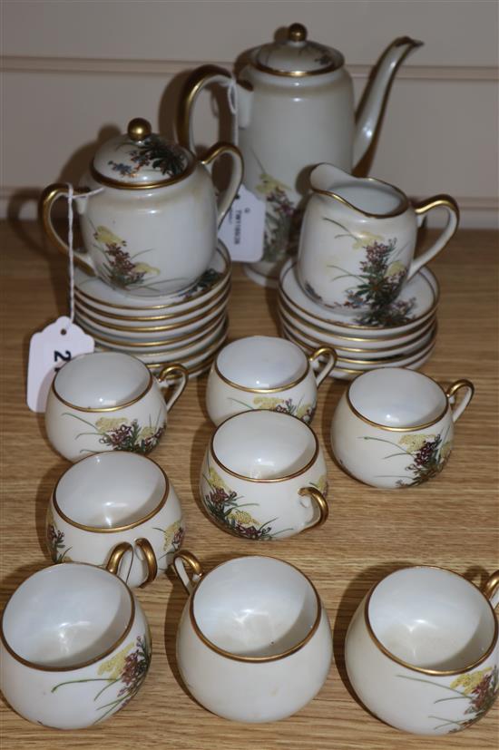 A Japanese Satsuma part coffee service, decorated with flowers and heightened in gilt, comprising coffee pot, cream jug,